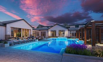 A large house with a swimming pool in front.